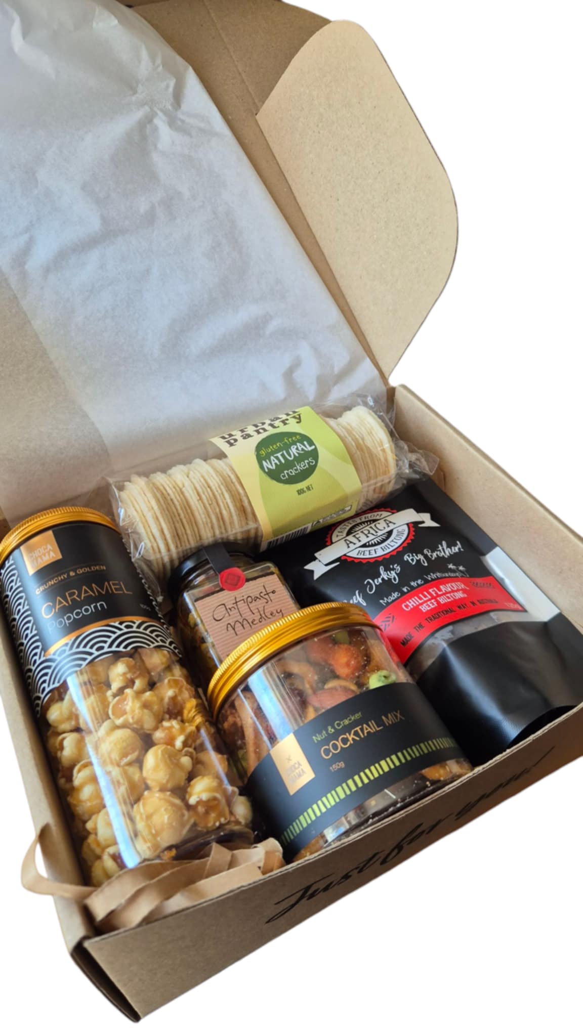 Box of snacks including a can of nuts, a jar of cookies, and a bag of chips.